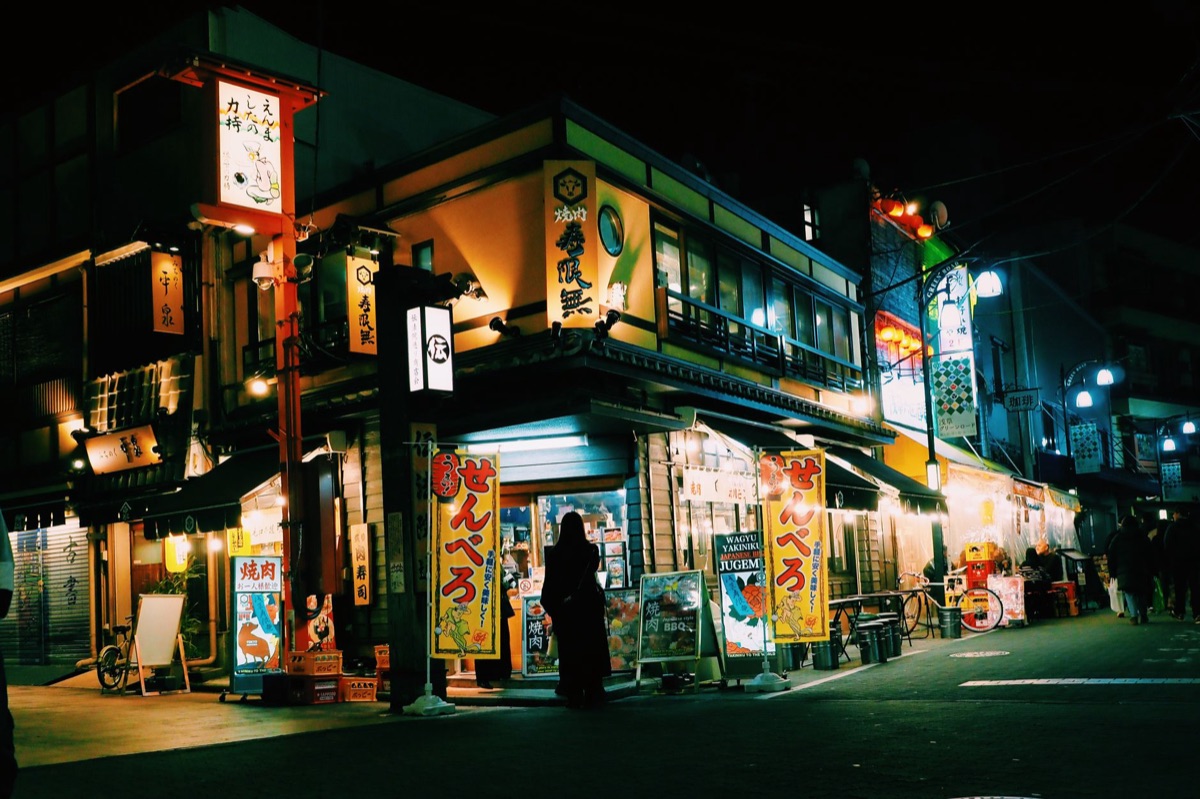 Local Tokyo street with neon signs and colorful storefronts