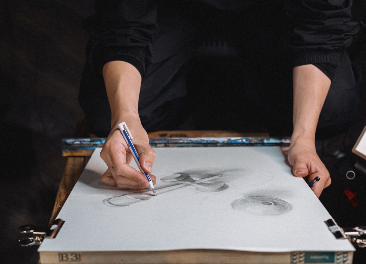 Japanese artist at studio with traditional and modern art supplies